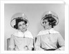 1960s two women sitting under hairdryers gossiping by Anonymous