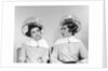 1960s two women sitting under hairdryers gossiping by Anonymous