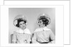 1960s two women sitting under hairdryers gossiping by Anonymous