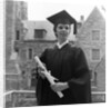 1950s smiling female graduate holding a diploma by Anonymous