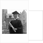 1950s smiling female graduate holding a diploma by Anonymous