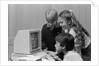 1980s boys and girl playing games on a computer by Anonymous