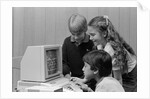 1980s boys and girl playing games on a computer by Anonymous