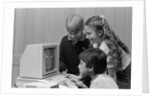 1980s boys and girl playing games on a computer by Anonymous