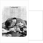 1930s man with head on his desk holding stock ticker tape by Anonymous