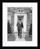 1950s smiling businessman walking out the front door of his house by Anonymous