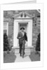 1950s smiling businessman walking out the front door of his house by Anonymous