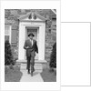 1950s smiling businessman walking out the front door of his house by Anonymous