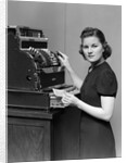 1930s 1940s portrait of female sales clerk at a cash register by Anonymous