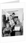 1960s family standing in doorway wearing winter coats and holding Christmas presents by Anonymous