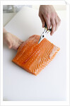 Deboning a salmon fillet by Anonymous