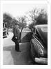 Mature man open his car door, ca. 1940. by Anonymous