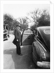 Mature man open his car door, ca. 1940. by Anonymous
