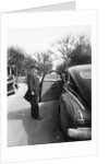 Mature man open his car door, ca. 1940. by Anonymous
