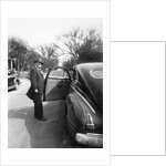 Mature man open his car door, ca. 1940. by Anonymous