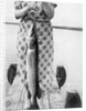 Woman holds on large Northern Pike on a lake pier, ca. 1950. by Anonymous