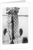 Woman holds on large Northern Pike on a lake pier, ca. 1950. by Anonymous