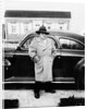 Mature man stands by his car, ca. 1942. by Anonymous