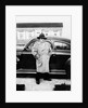 Mature man stands by his car, ca. 1942. by Anonymous