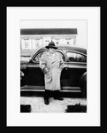 Mature man stands by his car, ca. 1942. by Anonymous