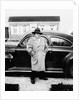 Mature man stands by his car, ca. 1942. by Anonymous