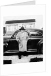Mature man stands by his car, ca. 1942. by Anonymous