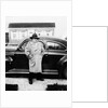 Mature man stands by his car, ca. 1942. by Anonymous