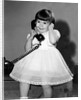 Young girl talks on the phone, ca. 1962. by Anonymous