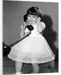 Young girl talks on the phone, ca. 1962. by Anonymous