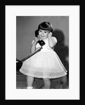 Young girl talks on the phone, ca. 1962. by Anonymous