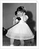 Young girl talks on the phone, ca. 1962. by Anonymous