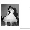 Young girl talks on the phone, ca. 1962. by Anonymous