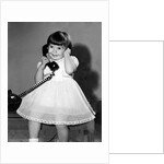 Young girl talks on the phone, ca. 1962. by Anonymous