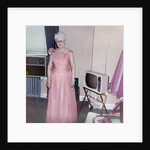 Grandma is all dressed up and standing next to a TV, ca. 1965 by Anonymous