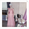 Grandma is all dressed up and standing next to a TV, ca. 1965 by Anonymous
