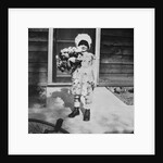 Young girl with a bouquet of flowers on her doorstep, ca. 1928. by Anonymous