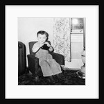 Young boy in his living room, ca. 1946. by Anonymous