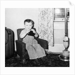 Young boy in his living room, ca. 1946. by Anonymous