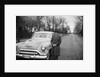 Senior man with his automobile on an Illinois street, ca. 1950. by Anonymous