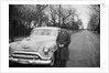 Senior man with his automobile on an Illinois street, ca. 1950. by Anonymous