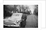 Senior man with his automobile on an Illinois street, ca. 1950. by Anonymous