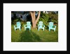 Turquois lawn chairs and green grass at sunset by Anonymous