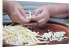 Woman selecting and separating green beans from pods by Anonymous