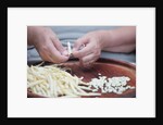 Woman selecting and separating green beans from pods by Anonymous
