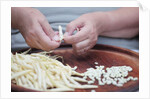 Woman selecting and separating green beans from pods by Anonymous