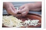 Woman selecting and separating green beans from pods by Anonymous