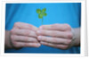 Man holding four-leaf clover by Anonymous