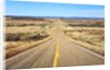 Long desert road stretching into the distance. by Anonymous
