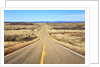 Long desert road stretching into the distance. by Anonymous