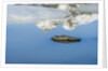 Rock with sky reflected in water. by Anonymous